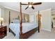 Charming main bedroom featuring a four-poster bed, neutral walls, and an ensuite bathroom access at 2196 Abbott Dr, Buford, GA 30519