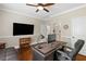 Well-appointed home office featuring hardwood floors, a ceiling fan, and a large monitor at 2196 Abbott Dr, Buford, GA 30519