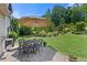 Outdoor dining area on the patio featuring a table, umbrella, and views of the beautiful backyard at 2196 Abbott Dr, Buford, GA 30519