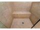 Tiled walk-in shower features a built-in seat and overhead shower head at 2196 Abbott Dr, Buford, GA 30519