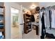 Walk-in closet with abundant shelving and clothing racks next to bathroom at 2196 Abbott Dr, Buford, GA 30519