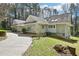 Back exterior showing a winding driveway, generous backyard, and access to a lower level entrance at 4859 Clark Lake Nw Way, Acworth, GA 30102