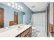 Blue bathroom with a tiled floor, single sink vanity and a shower with curtain at 4859 Clark Lake Nw Way, Acworth, GA 30102