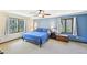 Serene bedroom with blue accent wall, two large windows with natural light, and comfortable decor at 4859 Clark Lake Nw Way, Acworth, GA 30102