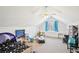 Spacious carpeted attic bedroom features white walls, built-in storage, and natural light from a window at 4859 Clark Lake Nw Way, Acworth, GA 30102
