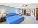 Cozy bedroom with a blue accent wall, a ceiling fan, and plenty of space for a desk or seating area at 4859 Clark Lake Nw Way, Acworth, GA 30102
