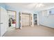 Carpeted bedroom with blue walls features folding closet doors, a window, and an additional room accessible through a doorway at 4859 Clark Lake Nw Way, Acworth, GA 30102