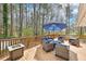 An outdoor deck space featuring a large seating area, umbrella and a firepit at 4859 Clark Lake Nw Way, Acworth, GA 30102