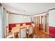 Bright dining room featuring a wooden table, decorative lighting, and stylish cabinets with glass doors at 4859 Clark Lake Nw Way, Acworth, GA 30102