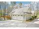 Spacious three-car garage with access to an upper level deck and surrounding greenery at 4859 Clark Lake Nw Way, Acworth, GA 30102