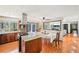 Open-concept kitchen features a breakfast bar island, stainless steel appliances, and hardwood floors at 4859 Clark Lake Nw Way, Acworth, GA 30102