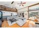 Large living room featuring vaulted ceilings, hardwood floors, access to a deck, and modern furnishings at 4859 Clark Lake Nw Way, Acworth, GA 30102