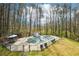 A beautiful fenced in pool featuring a large patio, a pool house, and furniture for relaxing at 4859 Clark Lake Nw Way, Acworth, GA 30102
