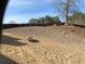 Spacious backyard with a stone fire pit and a wood fence for privacy at 1162 Mason Lee, Loganville, GA 30052