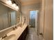 Bathroom with double vanity, updated mirror, and tile floors at 1162 Mason Lee, Loganville, GA 30052