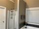 Bright bathroom featuring a shower with glass enclosure, a bathtub, and elegant decorative touches at 1162 Mason Lee, Loganville, GA 30052