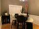 Stylish dining area with dark table and seating, complemented by natural light and modern decor at 1162 Mason Lee, Loganville, GA 30052