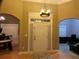 Inviting entryway with chandelier, transom window, and hardwood floors showcasing the home's style at 1162 Mason Lee, Loganville, GA 30052