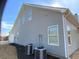 Exterior view of home showing siding, windows, and HVAC units at 1162 Mason Lee, Loganville, GA 30052