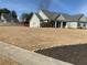 Traditional home featuring a well-manicured lawn, neutral siding, dark shutters, and a spacious covered porch at 1162 Mason Lee, Loganville, GA 30052