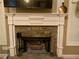 Elegant fireplace with stone surround, white mantel, and hearth, creating a cozy focal point in the home at 1162 Mason Lee, Loganville, GA 30052