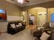 Cozy living room with plush leather seating, complemented by hardwood floors and arched doorways at 1162 Mason Lee, Loganville, GA 30052