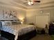 Bedroom with tray ceiling, ceiling fan and large floral artwork at 1162 Mason Lee, Loganville, GA 30052