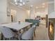 Open-concept dining room and kitchen with a marble table, modern light fixture, and stainless appliances at 1910 Cedar Glenn Way # 4401, Atlanta, GA 30339