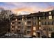 Condo exterior with balconies and landscaped grounds, offering a blend of residential charm and outdoor space at sunset at 1910 Cedar Glenn Way # 4401, Atlanta, GA 30339