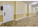 Condo hallway leading to a unit featuring carpeted floors and neutral walls with white trim, creating a welcoming entrance at 1910 Cedar Glenn Way # 4401, Atlanta, GA 30339