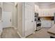 Well-lit kitchen showcasing stainless steel appliances, white cabinetry, and convenient access to the front door at 1910 Cedar Glenn Way # 4401, Atlanta, GA 30339
