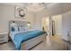 Calm main bedroom with ensuite bathroom featuring soft blue accents and decorative painting at 1910 Cedar Glenn Way # 4401, Atlanta, GA 30339
