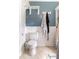 A quaint bathroom shows a toilet, wainscoting, and white shelving at 23 Peggy Nw Ct, Marietta, GA 30064