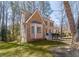 Attractive two-story home with brick, siding, a bay window, front porch, and surrounding greenery at 23 Peggy Nw Ct, Marietta, GA 30064