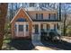 Attractive two-story home with brick and siding, a front porch, and a well-manicured lawn at 23 Peggy Nw Ct, Marietta, GA 30064