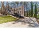 Beautiful two-story home with a long driveway, landscaping, front porch, and partial brick facade at 23 Peggy Nw Ct, Marietta, GA 30064