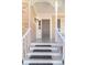 Welcoming front porch with white railings, dark gray door, and steps leading to the entrance at 23 Peggy Nw Ct, Marietta, GA 30064