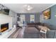 Inviting living room with a cozy fireplace and comfortable gray sectional sofa, perfect for relaxation at 23 Peggy Nw Ct, Marietta, GA 30064