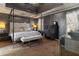 Luxurious main bedroom featuring a modern four-poster bed, complemented by stylish decor and natural light at 23 Peggy Nw Ct, Marietta, GA 30064