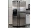 Stainless steel side-by-side refrigerator with water and ice dispenser, seamlessly integrated into the kitchen design at 23 Peggy Nw Ct, Marietta, GA 30064