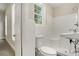 Simple bathroom features white tile shower and a classic white toilet and sink at 495 Hutchens Se Rd, Atlanta, GA 30354