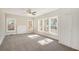 Large bedroom with plush carpet, multiple windows for ample natural light, and a ceiling fan at 495 Hutchens Se Rd, Atlanta, GA 30354