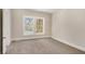 Cozy bedroom with neutral carpet, freshly painted walls and a window providing natural light at 495 Hutchens Se Rd, Atlanta, GA 30354
