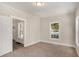 Cozy bedroom with plush carpet, large window, and neutral decor for a relaxing atmosphere at 495 Hutchens Se Rd, Atlanta, GA 30354