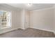 Neutral bedroom features a large window allowing for ample natural light and neutral carpeting at 495 Hutchens Se Rd, Atlanta, GA 30354