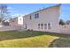 Fenced backyard with mature grass and a view to the house's back exterior at 720 Goldenrod Way, Norcross, GA 30093