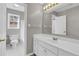 Bathroom featuring a single sink vanity with updated fixtures and a view to the tub and toilet at 720 Goldenrod Way, Norcross, GA 30093