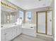 Bright bathroom with double sinks, a soaking tub, and a separate shower at 720 Goldenrod Way, Norcross, GA 30093