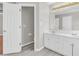 Bright bathroom featuring double vanity, ample storage, framed mirror, and modern fixtures at 720 Goldenrod Way, Norcross, GA 30093