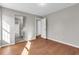 Bedroom showcasing wood flooring and a bathroom through the doorway at 720 Goldenrod Way, Norcross, GA 30093